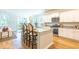 Open kitchen with white cabinets, stainless steel appliances, and barstool seating at 509 Yukon Ct, Lincolnville, SC 29485