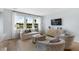 Bright living room with large windows, comfortable seating, and a modern entertainment center at 517 Verdi Dr, Summerville, SC 29486