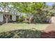 Lush backyard with green grass, mature trees, azalea bushes, and a classic home exterior at 649 Pawley Rd, Mount Pleasant, SC 29464