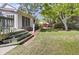 Charming backyard with well-kept lawn, mature shade trees, and a tiered deck with stairs at 649 Pawley Rd, Mount Pleasant, SC 29464