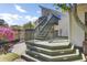 Multi-level deck with green railings, stairs, and beautiful foliage in a serene backyard setting at 649 Pawley Rd, Mount Pleasant, SC 29464