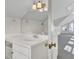 Bathroom features a vanity with storage, a large mirror, and access to the bright and airy attic space at 649 Pawley Rd, Mount Pleasant, SC 29464