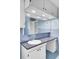 Bathroom featuring blue tile, vanity with black counter top, and large mirror with built-in lighting at 649 Pawley Rd, Mount Pleasant, SC 29464