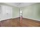 This bedroom has hardwood floors, ceiling fan, double door closet, and soft green walls at 649 Pawley Rd, Mount Pleasant, SC 29464