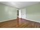 This bedroom has hardwood floors, double door closet, and soft green walls at 649 Pawley Rd, Mount Pleasant, SC 29464