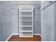 Walk-in closet featuring hardwood floors and installed shelves, with painted walls and ample storage space at 649 Pawley Rd, Mount Pleasant, SC 29464