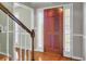 Foyer with hardwood flooring and wood staircase with glass pane windows on the sides at 649 Pawley Rd, Mount Pleasant, SC 29464