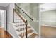 Stairway featuring hardwood steps, white risers and dark wood handrail at 649 Pawley Rd, Mount Pleasant, SC 29464