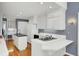 Spacious kitchen with all-white cabinetry, black countertops, and a breakfast bar overlooking the main living area at 649 Pawley Rd, Mount Pleasant, SC 29464