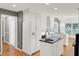 Bright kitchen with white cabinets, an island with a black countertop, and stainless steel appliances at 649 Pawley Rd, Mount Pleasant, SC 29464