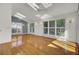 Bright living room featuring hardwood floors, skylights, recessed lights, and large windows with plantation shutters at 649 Pawley Rd, Mount Pleasant, SC 29464