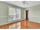 Bedroom with hardwood floors, large window with shutters and neutral paint at 649 Pawley Rd, Mount Pleasant, SC 29464