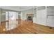 Open living room with hardwood flooring, brick fireplace, built-in shelving, and access to an adjoining room at 649 Pawley Rd, Mount Pleasant, SC 29464