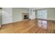 Cozy living room boasting hardwood floors, a brick fireplace, built-in storage, and a large window at 649 Pawley Rd, Mount Pleasant, SC 29464