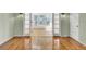 Bright living room featuring hardwood floors, double French doors, and natural light from the windows at 649 Pawley Rd, Mount Pleasant, SC 29464