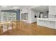 Sunlit living room featuring hardwood floors, tall ceilings, and French doors leading to the backyard at 649 Pawley Rd, Mount Pleasant, SC 29464