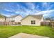 Lush backyard featuring a well-maintained lawn, wooden fence, and outdoor seating area at 7120 Sweetgrass Blvd, Hanahan, SC 29410