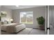 Cozy bedroom with neutral decor, ample natural light, and views of the backyard at 7120 Sweetgrass Blvd, Hanahan, SC 29410