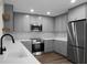 Modern kitchen with stainless steel appliances, grey cabinetry, quartz countertops and subway tile backsplash at 7120 Sweetgrass Blvd, Hanahan, SC 29410