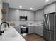 Modern kitchen with stainless steel appliances, grey cabinetry, quartz countertops and subway tile backsplash at 7120 Sweetgrass Blvd, Hanahan, SC 29410