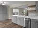 Bright, open kitchen with stainless steel appliances, granite counters, and view into the living area at 7120 Sweetgrass Blvd, Hanahan, SC 29410