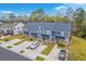 Aerial view showcases blue townhomes, individual driveways, and carefully maintained landscaping at 7803 Park Gate Dr, Charleston, SC 29418