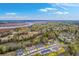 Beautiful aerial view of marsh-front home community and surrounding wooded landscape at 7803 Park Gate Dr, Charleston, SC 29418