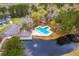 Birds eye view of a community pool with surrounding foliage and a pond and clubhouse at 7803 Park Gate Dr, Charleston, SC 29418