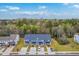 Aerial view showing well-planned community with blue townhomes surrounded by green trees and a large field at 7803 Park Gate Dr, Charleston, SC 29418