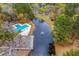 Overhead shot of a community pool, pond, clubhouse, and wooded landscape from above at 7803 Park Gate Dr, Charleston, SC 29418