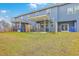 Backyard view of the property featuring a covered patio, lawn, and a two-story home at 7803 Park Gate Dr, Charleston, SC 29418