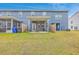 Backyard view featuring a covered patio, lawn, and a two-story home at 7803 Park Gate Dr, Charleston, SC 29418