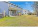 Backyard view of the property featuring a covered patio, lawn, and a two-story home at 7803 Park Gate Dr, Charleston, SC 29418