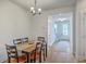 Cozy dining room featuring a wooden table set for six, with natural light at 7803 Park Gate Dr, Charleston, SC 29418
