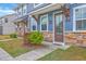 Charming home entrance with stylish door, stone accents, and landscaped pathway at 7803 Park Gate Dr, Charleston, SC 29418