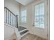 Bright foyer featuring staircase, wood floors, and natural light from the door window at 7803 Park Gate Dr, Charleston, SC 29418