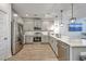 Well-lit kitchen features gray cabinetry, stainless appliances, and stone countertops at 7803 Park Gate Dr, Charleston, SC 29418