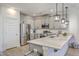 Modern kitchen with stainless steel appliances, island with stone countertops, and pendant lighting at 7803 Park Gate Dr, Charleston, SC 29418