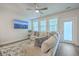 Inviting living room with a large sectional sofa, ceiling fan, and view of the Charleston bridge at 7803 Park Gate Dr, Charleston, SC 29418