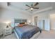 This main bedroom includes ceiling fan, tray ceiling, and ensuite bathroom at 7803 Park Gate Dr, Charleston, SC 29418