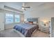 Cozy main bedroom boasts tray ceiling, ceiling fan, and plenty of natural light at 7803 Park Gate Dr, Charleston, SC 29418