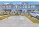 Charming townhomes featuring stone accents, blue siding, and a convenient two-car driveway at 7803 Park Gate Dr, Charleston, SC 29418