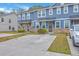 Blue townhomes with stone accents, featuring private entryways and ample parking at 7803 Park Gate Dr, Charleston, SC 29418
