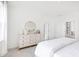 Bright bedroom featuring a dresser with round mirror and white bedding at 792 Clay Field Trl, Summerville, SC 29485