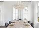 Bright dining room featuring a modern chandelier and a wooden table set for dinner at 792 Clay Field Trl, Summerville, SC 29485