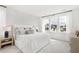 Serene main bedroom with a large bed, patterned wallpaper, and bright windows at 792 Clay Field Trl, Summerville, SC 29485