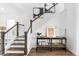 Elegant staircase with dark wood railings and white spindles leading upstairs at 792 Clay Field Trl, Summerville, SC 29485