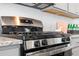 Close-up of a stainless steel stove with granite countertops and a white subway tile backsplash at 792 Clay Field Trl, Summerville, SC 29485