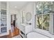 Bright bathroom with white vanity, a round mirror and a large window showcasing natural light at 8115 Adams Run School Rd, Adams Run, SC 29426