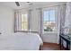 Bright bedroom with hardwood floors, light walls, and windows offering a pleasant neighborhood view at 8115 Adams Run School Rd, Adams Run, SC 29426